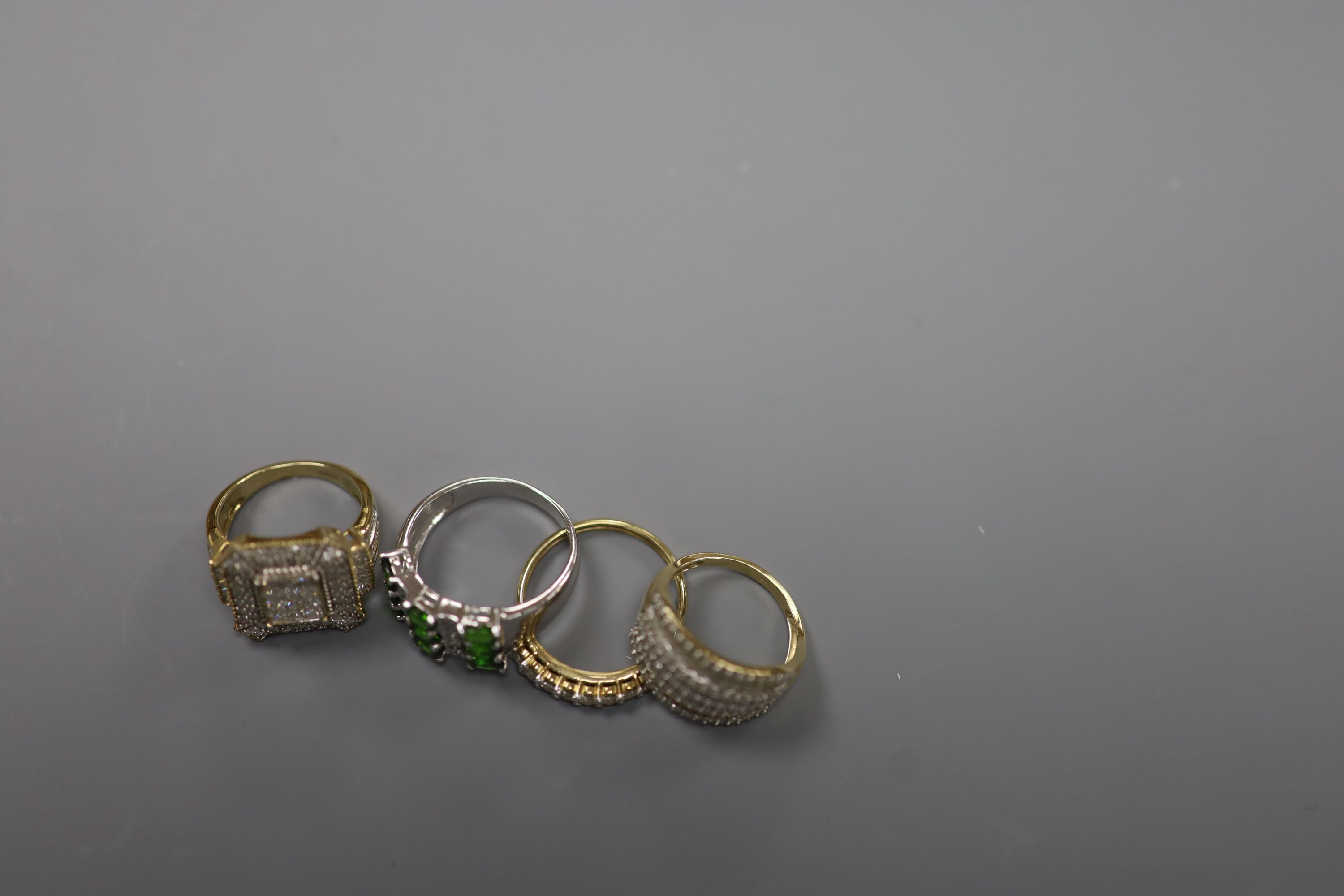 Two modern 9ct gold and pave set diamond dress rings, size N/O and a similar 9ct gold and nine stone diamond set half hoop ring, size R/S, gross 11.3 grams and one other 925 ring.